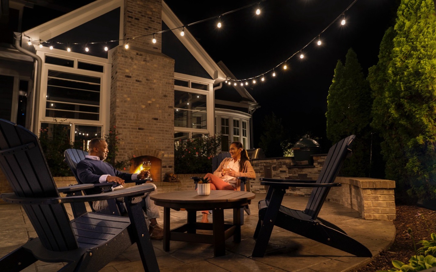 A group of people sitting around a table outside
Description automatically generated